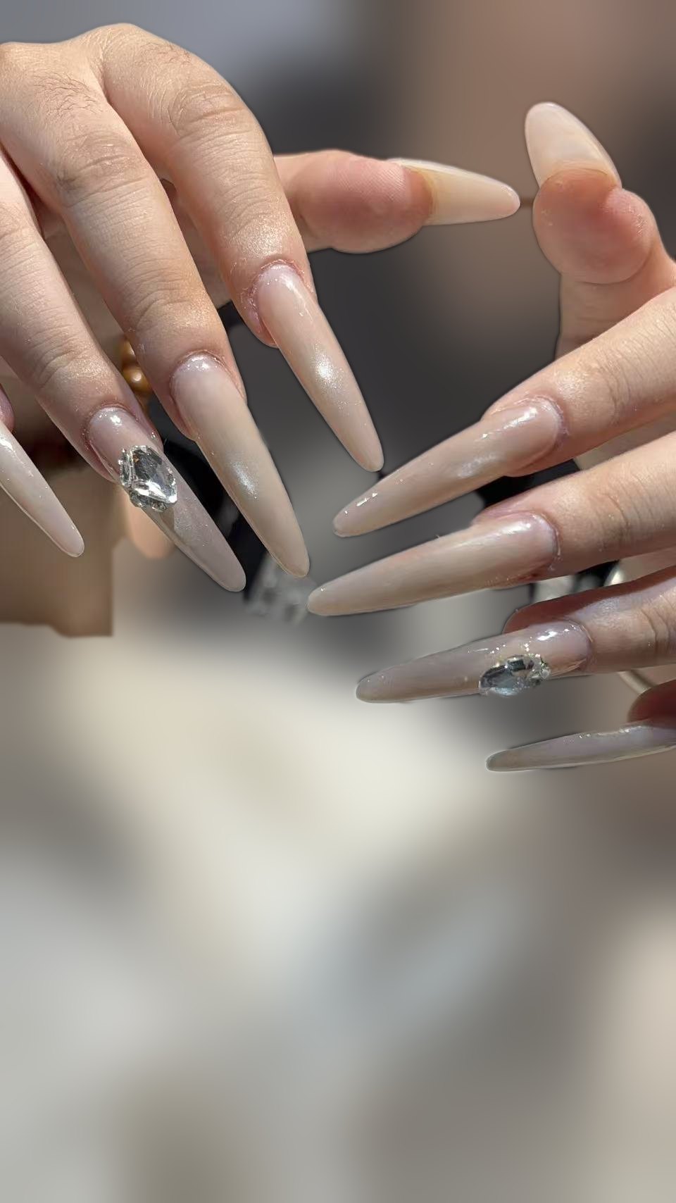 Long nude stiletto extensions set with large crystal stones
